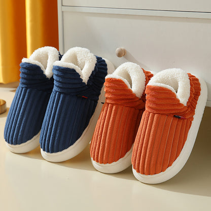 Pair of navy blue and orange plush slippers with white fleece lining, cozy indoor footwear