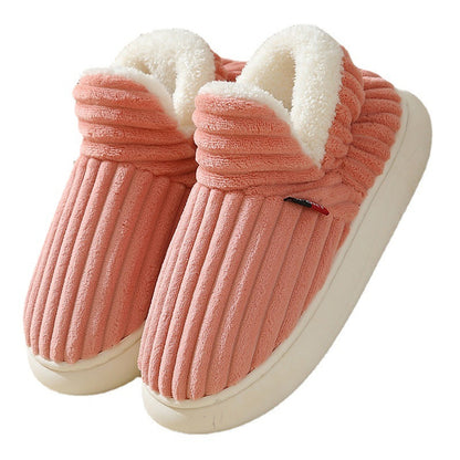 Pair of pink plush slippers with white sherpa lining and ribbed texture on white soles