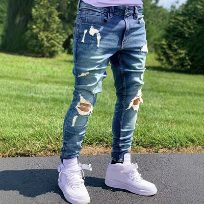 Men's ripped peacock blue skinny jeans with medium elastic fit worn outdoors with white sneakers