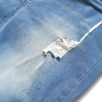 Close-up of peacock blue men's ripped denim jeans with distressed detailing and straight leg fit