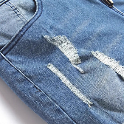 Close-up of peacock blue ripped men's jeans with distressed details and medium elasticity
