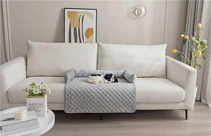 White modern sofa with gray quilted pet sofa bed and black and white dog resting