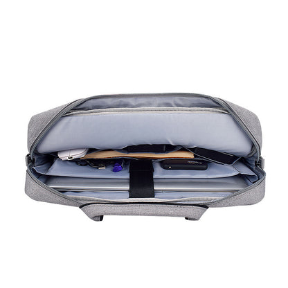 gray laptop shoulder bag open showing organized compartments with laptop, charger, and accessories