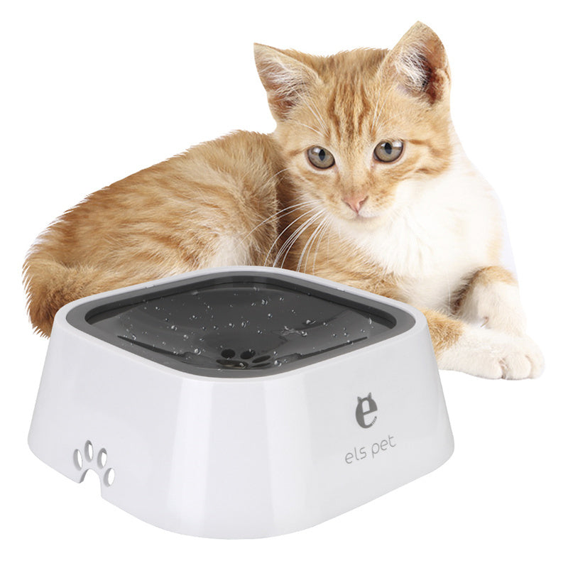 Orange tabby cat lying next to white els pet water bowl with black anti-overflow lid
