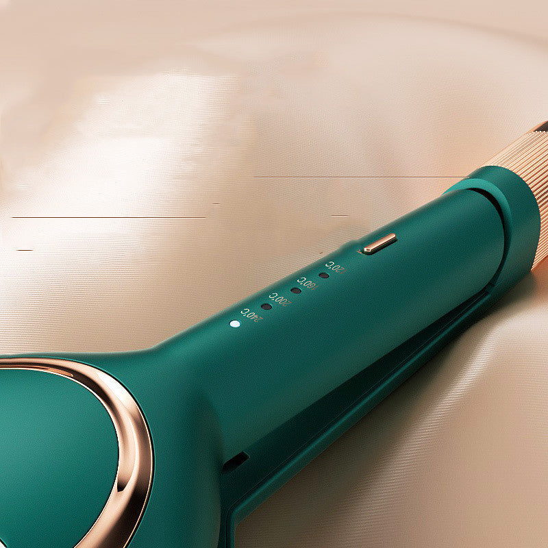 Close-up of teal curling iron handle with gold accents and temperature settings on beige background