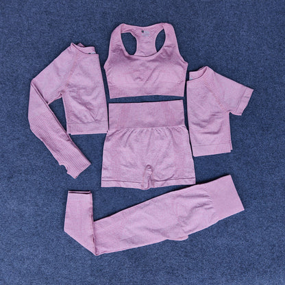 Pink 5-piece athleisure set including sports bra, long sleeve crop top, short sleeve crop top, high waist shorts, and leggings on gray background
