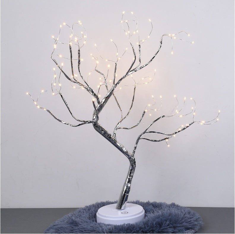 LED bonsai tree light with glowing warm white lights on silver branches on a white base