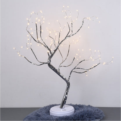 LED bonsai tree light with glowing warm white lights on silver branches on a white base