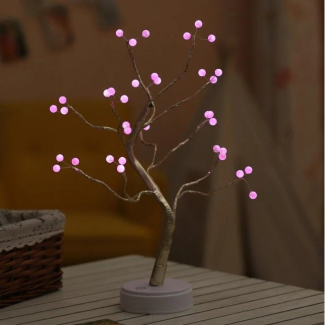 Pink LED bonsai tree lamp with adjustable USB-powered base on white table