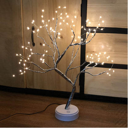 LED bonsai tree light with warm white pearl lights on silver wire branches, on wooden floor