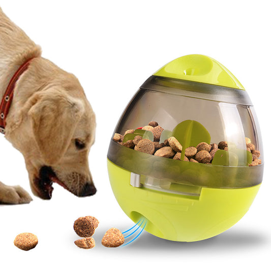yellow interactive pet feeder toy dispensing kibble with a dog eating nearby