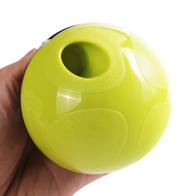 Hand holding a lime green slow feeder pet toy ball with textured grip and treat opening