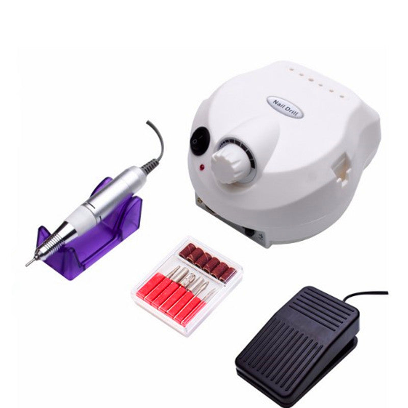 Electric nail drill kit with white control unit, silver handpiece on purple stand, black foot pedal, and nail drill bits