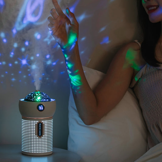 Nighttime room with pink USB humidifier projecting colorful star patterns on wall and arm
