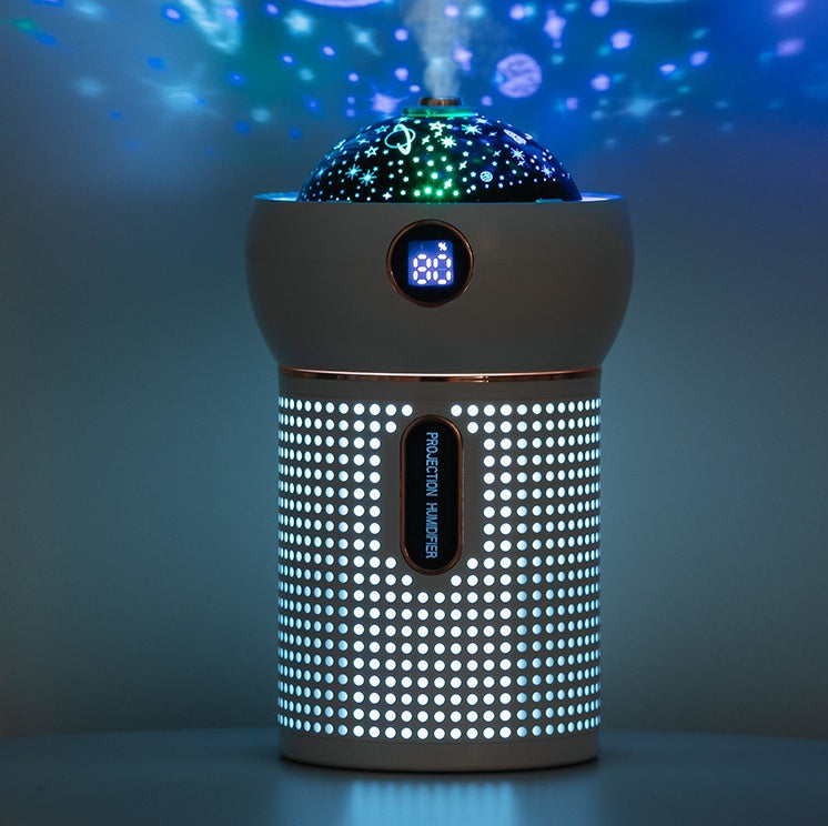 Modern white projection humidifier with star and planet light display in dark room