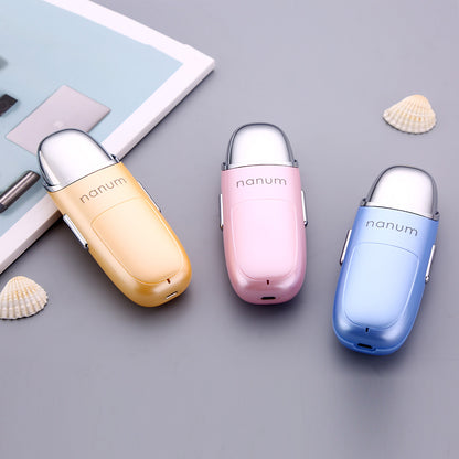 Three Nanum portable nano mist sprayers in yellow, pink, and blue on gray background with seashells