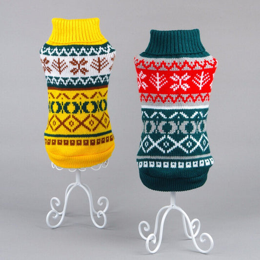 Two knitted dog sweaters with colorful Fair Isle patterns on white decorative stands against gray background