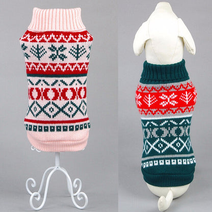 Two knitted dog sweaters with festive patterns in pink, red, green, and white displayed on mannequins