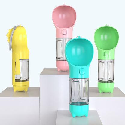 Portable 500ml pet water bottles in yellow, pink, turquoise, and green with attached bowls on white display blocks