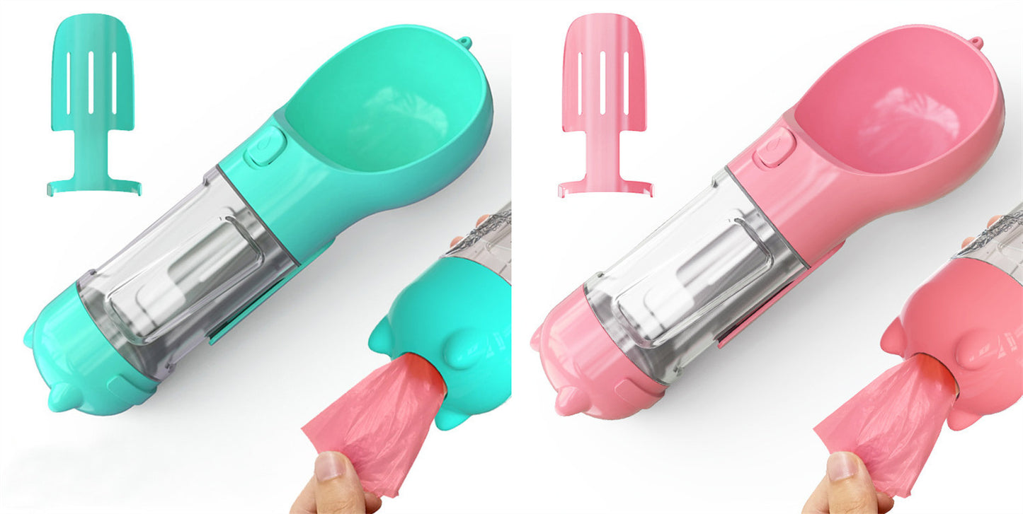 Portable 3-in-1 pet water bottle and feeder in pink and teal with attached scoop and waste bag dispenser