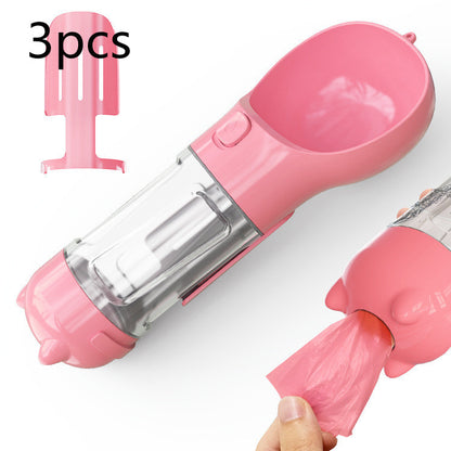 Pink 3-in-1 portable dog water bottle with attached pet feeder and dispenser for waste bags