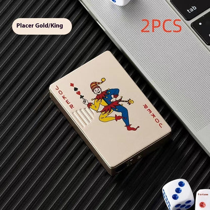 Zinc alloy poker card lighter with joker design, placed on black surface near laptop and dice
