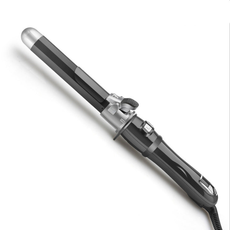 Black automatic curling iron with ceramic barrel and LCD display on white background