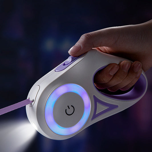 Hand holding a white and purple retractable dog leash with LED light and ergonomic handle