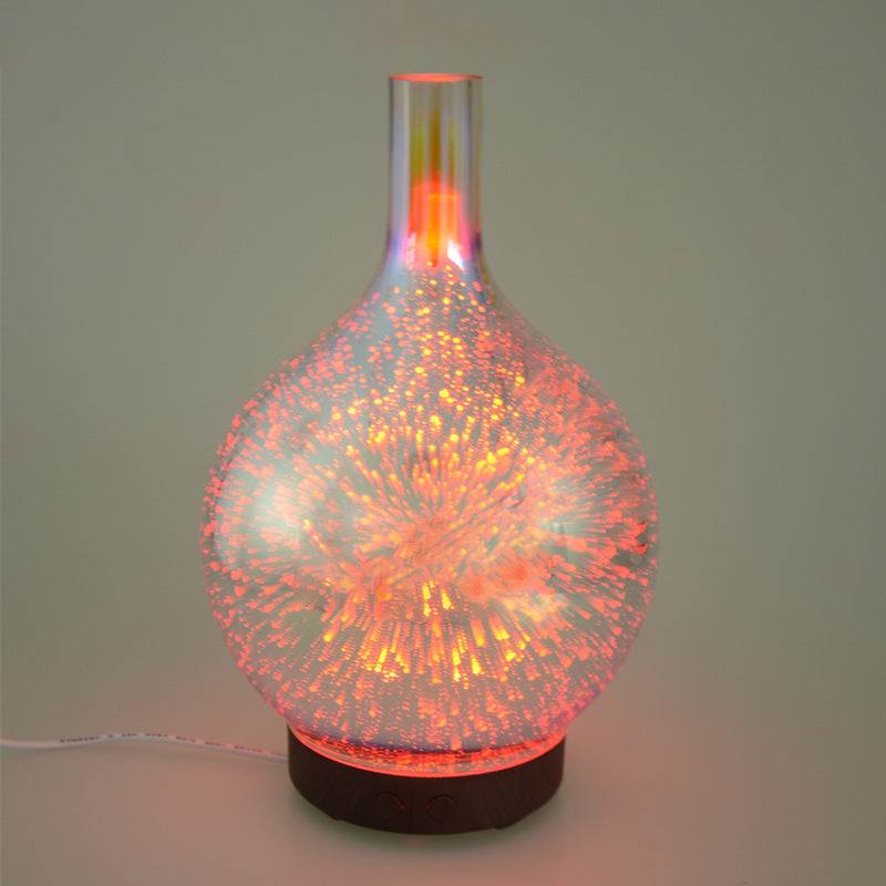 Purple 3D firework glass ultrasonic diffuser with glowing orange light on dark base