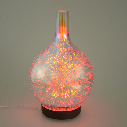 Purple 3D firework glass ultrasonic diffuser with glowing orange light on dark base