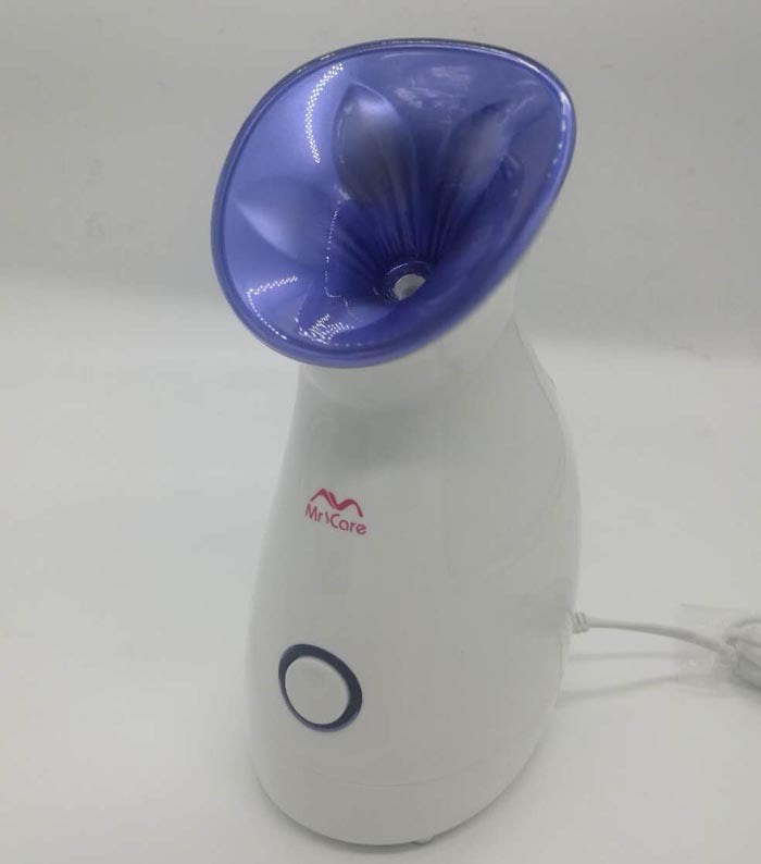 White Mr Care facial steamer with purple nozzle, designed for skin moisturizing and hot spray