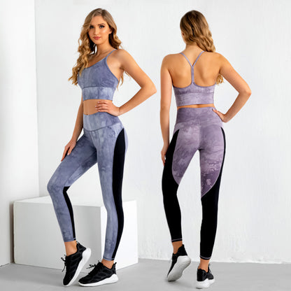 Woman wearing purple tie-dye sleeveless crop top and leggings gym suit with black side panels