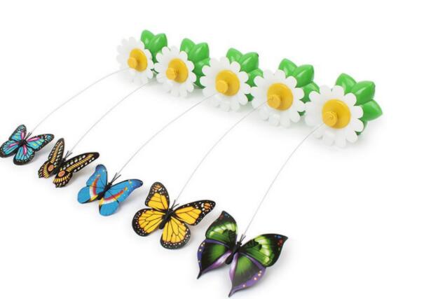 Set of five butterfly toys attached to white and yellow daisy bases with green leaves on white background