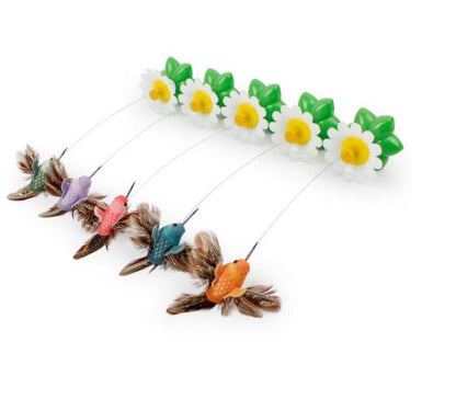 Electric rotating cat toy with colorful bird figures and daisies on green base, remote control