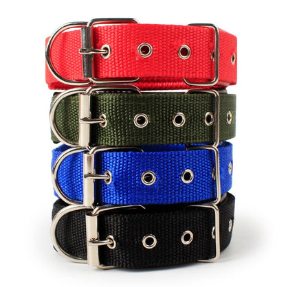Stack of adjustable pet collars in red, green, blue, and black with metal buckles and eyelets