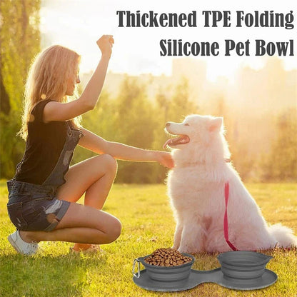 Young woman playing with white fluffy dog on grass with collapsible grey silicone pet bowl filled with food
