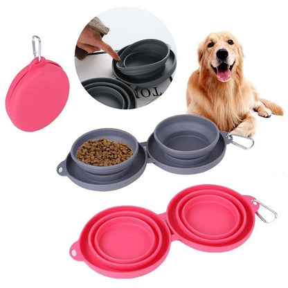 Red and gray collapsible double dog bowls with carabiner clips and a golden retriever in background