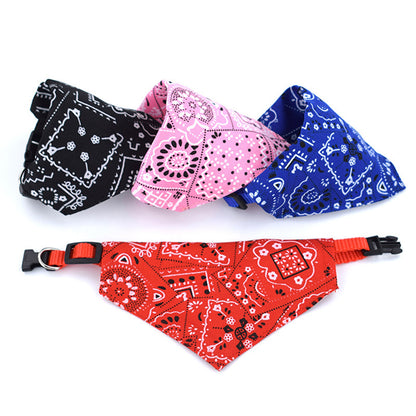 Set of adjustable pet bandanas in red, black, pink, and blue with paisley print on white background