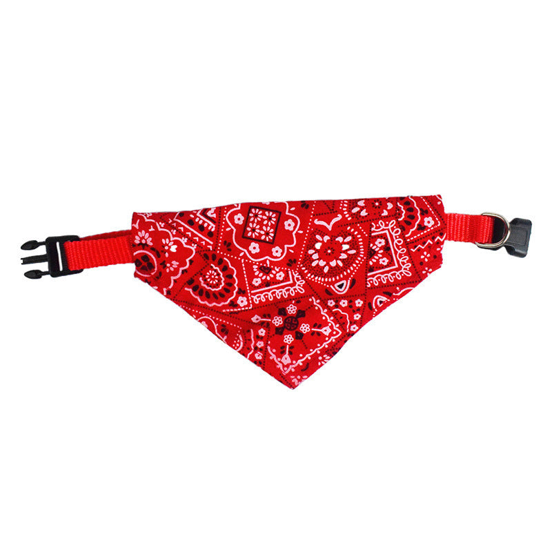 Red dog bandana with white paisley pattern and adjustable buckle strap on white background