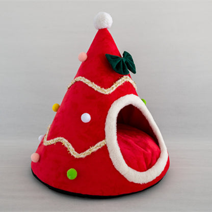 Red Christmas-themed cozy pet bed shaped like a festive tree with colorful pom-pom decorations and a green bow