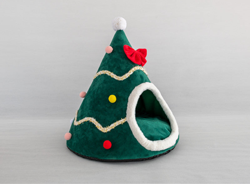 Cozy Christmas tree-shaped pet bed with red bow, colorful pom-poms, and soft plush interior