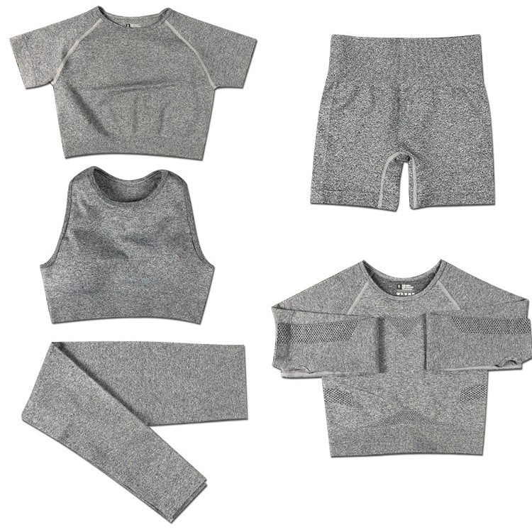 Gray women's seamless yoga set with crop tops, leggings, shorts, and long sleeve top