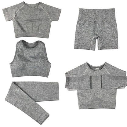 Gray women's seamless yoga set with crop tops, leggings, shorts, and long sleeve top