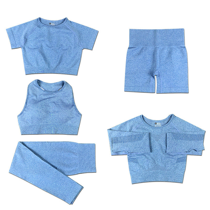 Light blue seamless women's activewear set with crop tops, leggings, shorts, and long-sleeve top