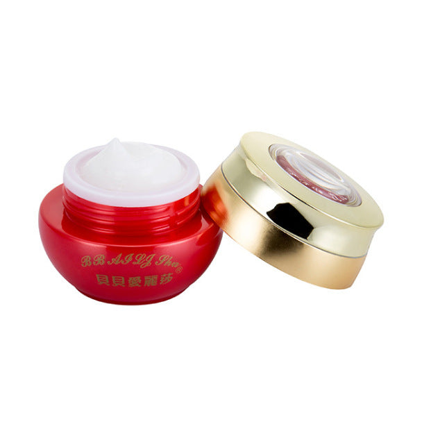 Open red and gold jar of BB cream with white moisturizing facial cream inside on white background