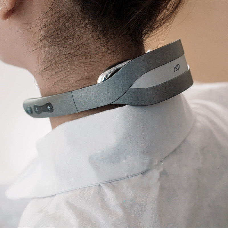 Person wearing a gray neck massager with control buttons on the side, designed for pulse therapy and heat