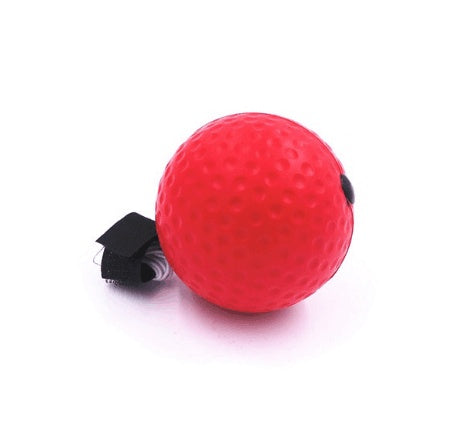 Red boxing reflex punching ball with dimpled surface and elastic strap on white background