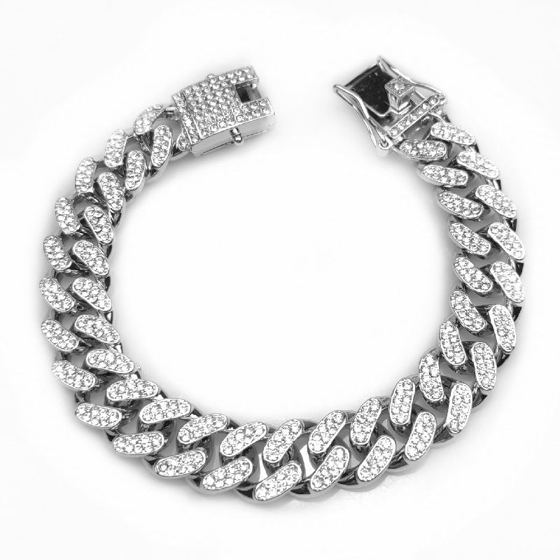 Silver Cuban link chain bracelet with embedded sparkling crystals and secure clasp on white background