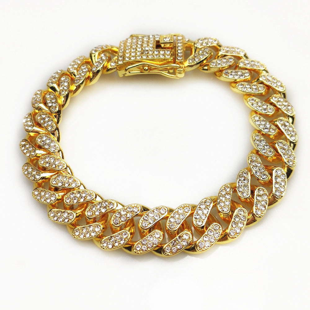 Gold-tone hip hop chain bracelet with rhinestone accents and secure clasp on white background