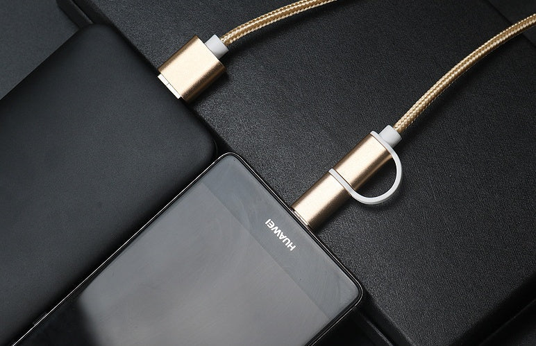Rose gold braided 2-in-1 USB-C and micro USB fast charger cable connected to a black Huawei smartphone on black surface